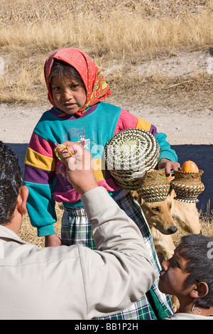 Young girl receives fruit and school supplies given as gifts in the Tarahumara village of San Alonso in Copper Canyon Mexico Stock Photo