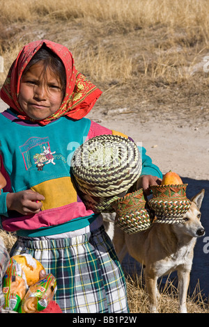 Young girl receives fruit and school supplies given as gifts in the Tarahumara village of San Alonso in Copper Canyon Mexico Stock Photo