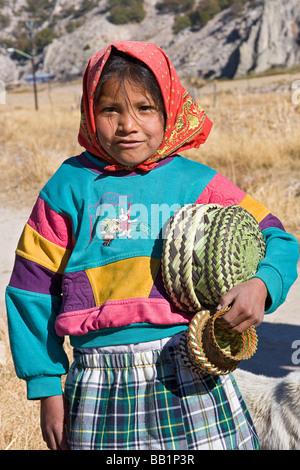 Young girl receives fruit and school supplies given as gifts in the Tarahumara village of San Alonso in Copper Canyon Mexico Stock Photo