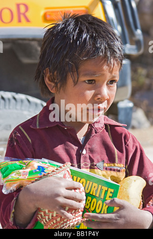 Young boy receives fruit and school supplies in the Tarahumara village of San Alonso in Copper Canyon Stock Photo