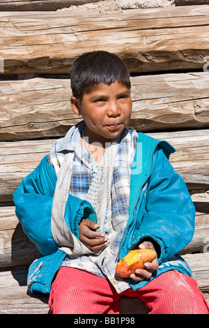 Young girl sits by her simple adobe and log home in the Tarahumara village  of San Alonso in the Copper Canyon area of Mexico Stock Photo - Alamy