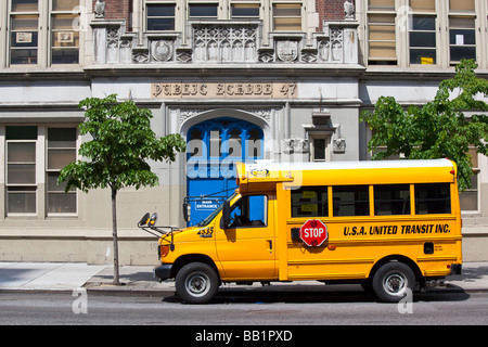 Public School and Yellow School Bus in New York City Stock Photo