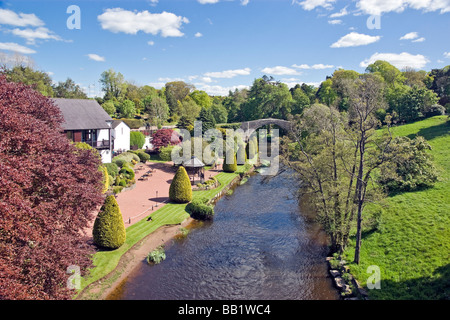 Medieval Brig O’Doon at the Burns National Heritage Park in Alloway Scotland spanning the River Doon in the background. Stock Photo