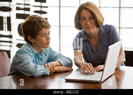 Woman and her grandson using a laptop Stock Photo