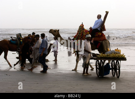 Pakistani s enjoying the camels and the sea on Clifton beach Karachi Pakistan Stock Photo