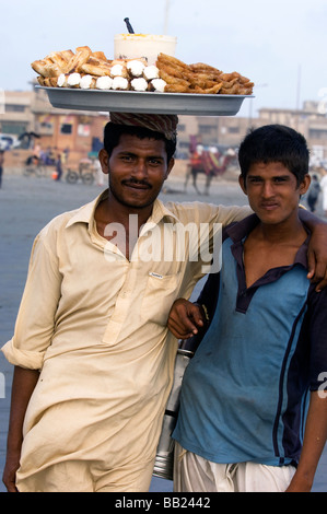 Pakistani s enjoying the camels and the sea on Clifton beach Karachi Pakistan Stock Photo