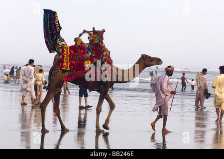 Pakistani s enjoying the camels and the sea on Clifton beach Karachi Pakistan Stock Photo