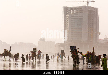 Pakistani s enjoying the camels and the sea on Clifton beach Karachi Pakistan Stock Photo