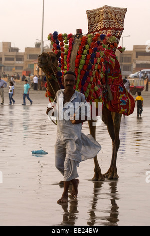 Pakistani s enjoying the camels and the sea on Clifton beach Karachi Pakistan Stock Photo