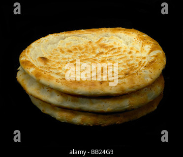 original fresh uzbek bread isolated over black background Stock Photo