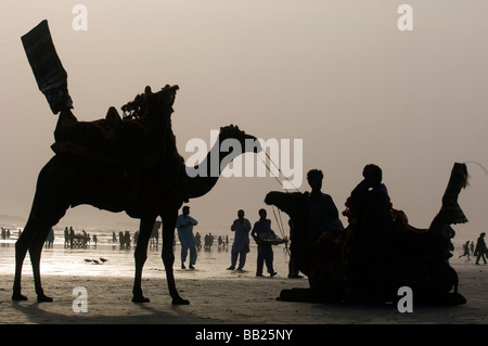 Pakistani s enjoying the camels and the sea on Clifton beach Karachi Pakistan Stock Photo