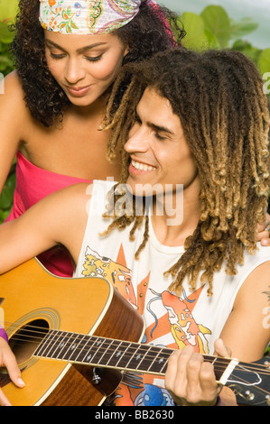 Couple playing a guitar Stock Photo
