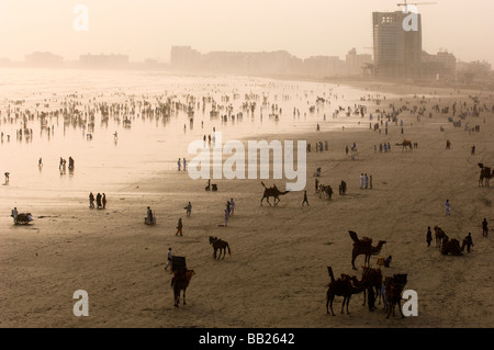 Pakistani s enjoying the camels and the sea on Clifton beach Karachi Pakistan Stock Photo