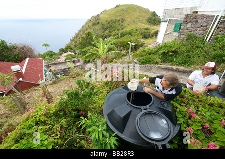 Saba a mosquito control officer is releasing guppies in a cistern The fish eat the mosquito larves Stock Photo