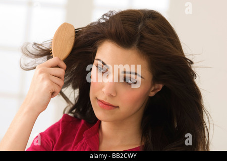 Close-up of a woman brushing her hair Stock Photo