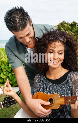 Couple playing ukulele Stock Photo