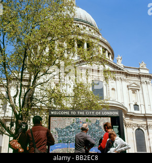 Tourists near St Paul s Cathedral reading a map of London England UK Stock Photo