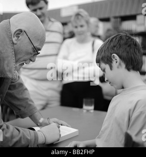 British author Brian Jacques book signing for a young boy at the Hay Festival, Hay on Wye, Wales UK Stock Photo
