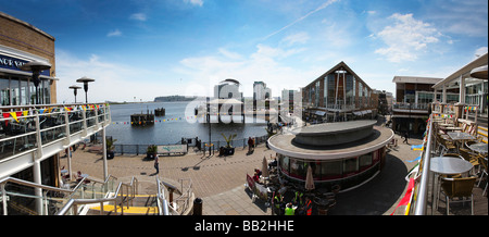 Cardiff Bay waterfront area with restaurants cafes promenade and views over inner harbour towards St Davids hotel, Cardiff Wales Stock Photo