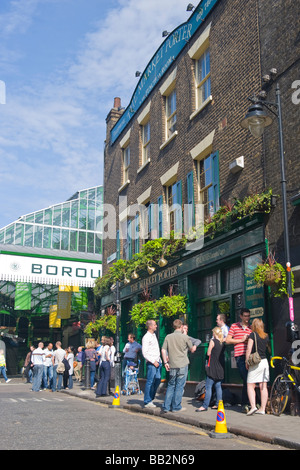 London Borough Market exterior of The Market Porter pub public house drinkers enjoy a quiet beer in the spring sun cloud hanging baskets window boxes Stock Photo