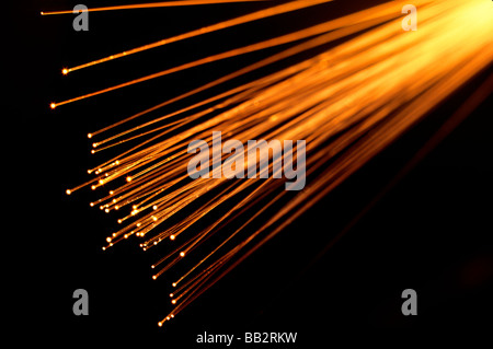 Fiber Optic Strands aglow transmitting light images through transparent fibers. Stock Photo