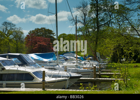 Boats moored at the Swan Hotel Marina, next to the Swan Hotel, Newby Bridge, Lake District National Park, Cumbria, England UK Stock Photo