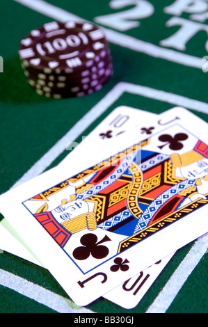 casino chips and playing cards on a casino playing table Stock Photo