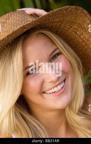 Portrait of a woman wearing sun hat and smiling Stock Photo