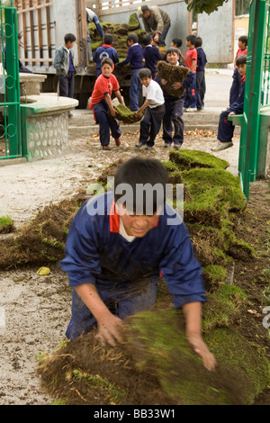 South America, Ecuador, Lasso, school children doing community service project at church garden Stock Photo