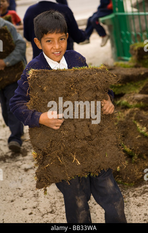 South America, Ecuador, Lasso, school children doing community service project at church garden Stock Photo