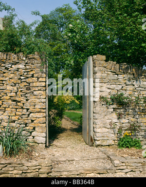 Garden gate in an old stone wall Stock Photo