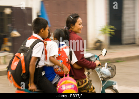 Mother with three children on motorcycle, Luang Prabang, Northern Laos, Southeast Asia Stock Photo