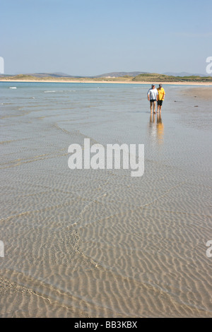 couple strolling on the unspoiled beach at Narin, County Donegal, Ireland Stock Photo