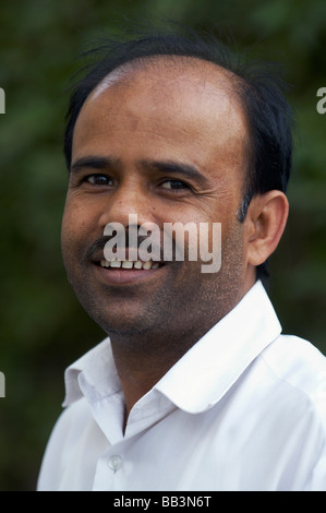 The smiling  Indian man looking at the camera. Stock Photo