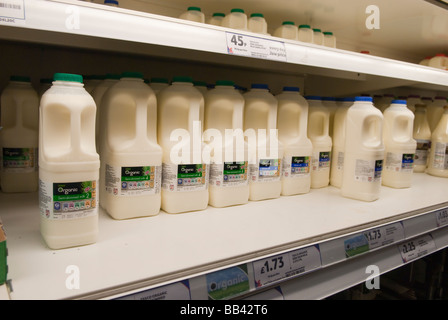 Plastic bottles of organic milk for sale on the shelf at a uk supermarket (Tesco) Stock Photo