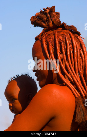 Himba woman and his small baby. This is one of the Namibia´s most famous tribes from the northern region, Namibia.