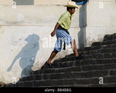 Villagers walking up steps into church Stock Photo