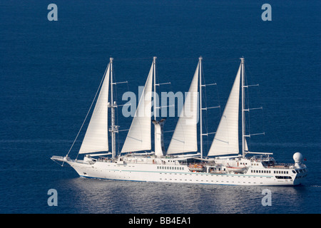 Europe, Greece, Santorini, Thira, Oia. Close-up of four-masted yacht Windstar as it sails out to sea on a luxury cruise. Stock Photo