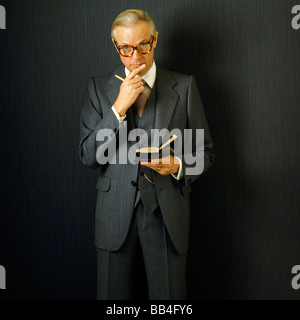 ELDERLY BUSINESSMAN WITH NOTEBOOK Stock Photo