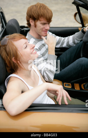Portrait of of young couple in a car smiling Stock Photo