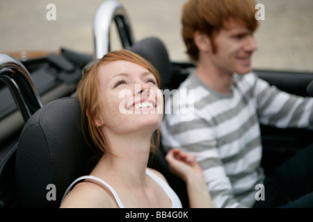 Portrait of of young couple in a car smiling Stock Photo