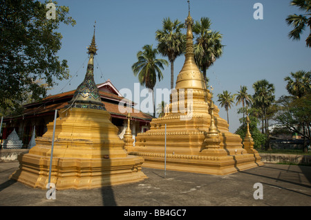 Gold painted stone Stupas in a Burmese temple in Chiang Mai Northern Thailand Stock Photo