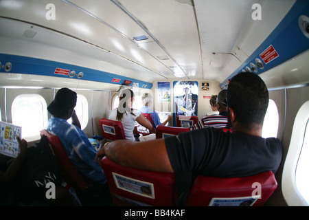 People on a small Twin Otter airplane while flying to the Caribbean isle Saba in the Netherlands Antilles Stock Photo