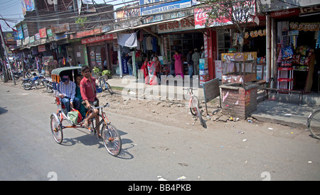 Man on bicycle rickshaw with passenger in street of Kathmandu Nepal Asia. Horizontal 93147 Nepal Stock Photo