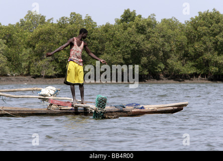 Senegal: Fisherman in his dugout canoe on the river Casamance Stock Photo