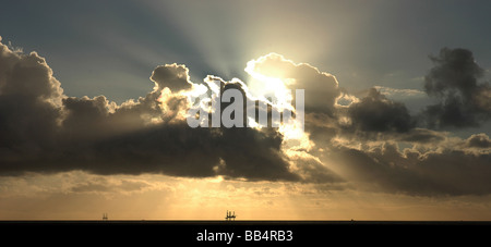 Dramatic sunburst over Irish Sea gas platform Stock Photo