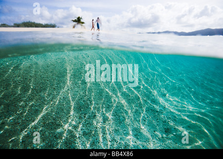 couple walking along beach on Sandy Spit Island