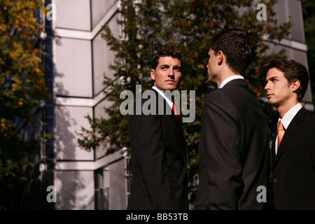 three man in front of a business building Stock Photo