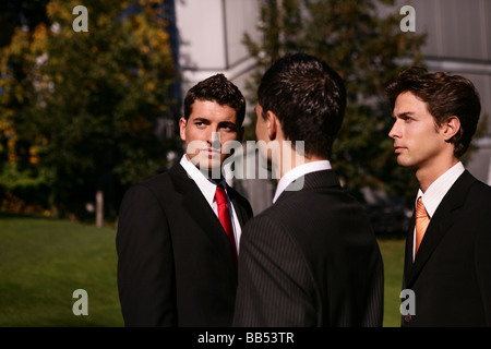 three man in front of a business building Stock Photo