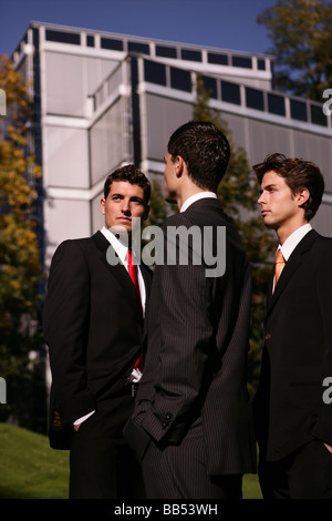 three man in front of a business building Stock Photo